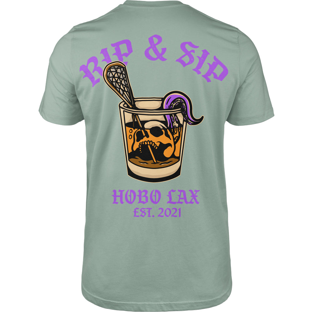 Rip &amp; Sip Tee in seafoam, back view, whisky glass with skull, lacrosse stick and purple tentacle under RIP &amp; SIP and HOBO LAX EST. 2021