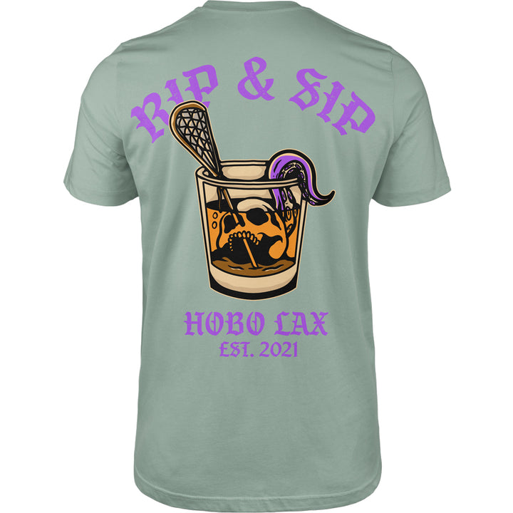 Rip &amp; Sip Tee in seafoam, back view, whisky glass with skull, lacrosse stick and purple tentacle under RIP &amp; SIP and HOBO LAX EST. 2021