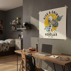 Room interior with a desk, laptop, and 'Rise & Grind Hobolax' poster on the wall.