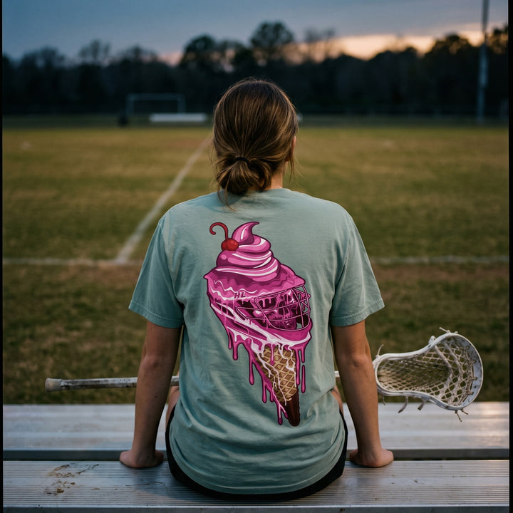 Sideline Scoop lacrosse tee in seafoam, back print worn by a player on the bleachers